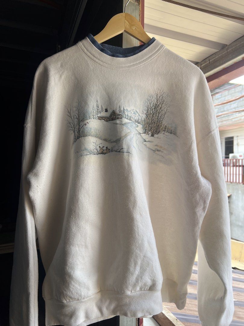 Morning Sun Winter Scene Sweatshirt (Category: Coats, Jackets and Outerwear) located in Cavite. Submitted by johnlei_ (Listing ID 1438006589, Image 2). Description: - Double-layered collar with navy blue inner layer - Graphic depicts a cabin, trees, and a snowy landscape - Ribbed cuffs on sleeves and hem - Brand: "Morning Sun" - Dimensions width:26 length: 27 -Meduim fitting .