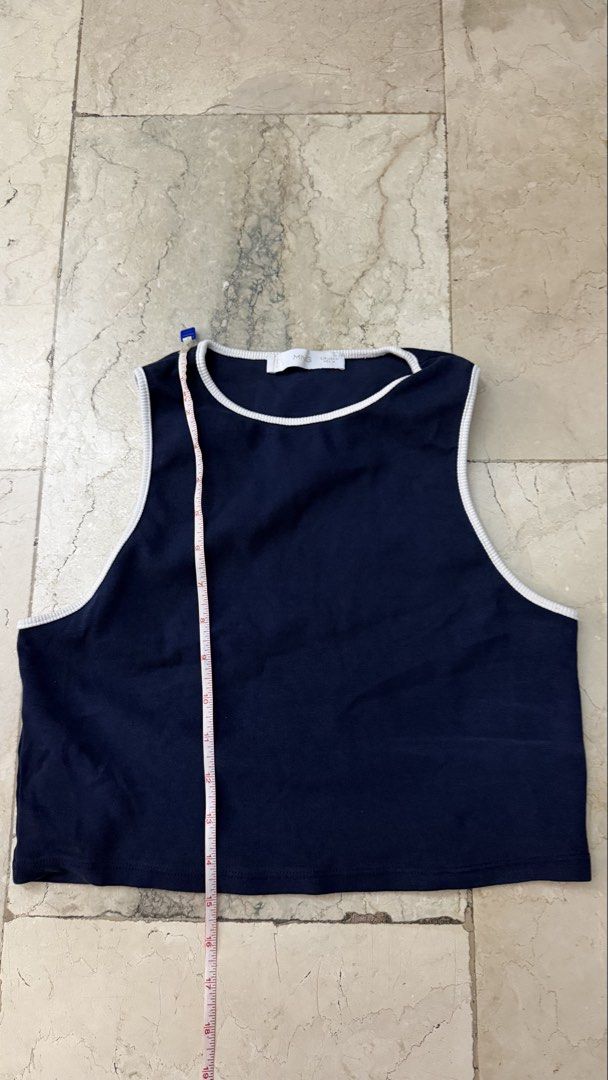 Mango Navy Blue Tank Top with White Trim (Category: Sleeveless) located in Quezon City. Submitted by margaritababy (Listing ID 1438071323, Image 2). Description: - Navy blue tank top - White trim on neckline and armholes - Cropped length - Comfortable fabric - Measurements in photos - Simple and versatile.