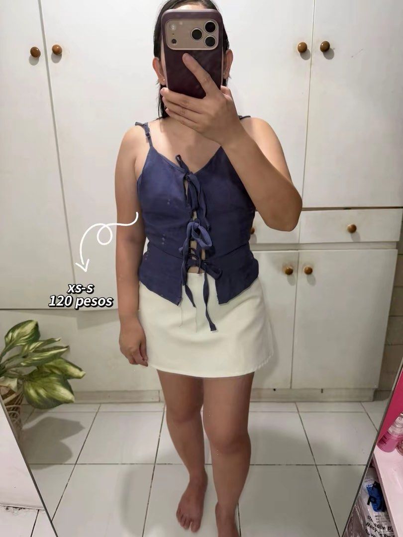 Navy Blue Tie-Up Top XS-S (Category: Sleeveless) located in Marikina City. Submitted by feibella_clothing24 (Listing ID 1438089975, Image 1). Description: - Navy blue tie-up top - Size: XS-S - Features a V-neckline - Tie-up detail in the front - Thin straps - Price: 120 pesos.