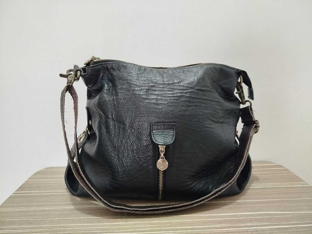 Nicole Miller Leather Hobo/Shoulder Bag (Category: Shoulder Bags) located in Cavite. Submitted by prncs.jc (Listing ID 1437995616, Image 1). Description: Product Description: - Item: Nicole Miller Leather Hobo/Shoulder Bag - Color: Classic Black - Material: Genuine Leather - Closure: Top zipper closure - Handle/Strap: Detachable leather shoulder strap with sturdy metal lobster claws Interior: - Dark brown monogrammed fabric lining - Multiple inte