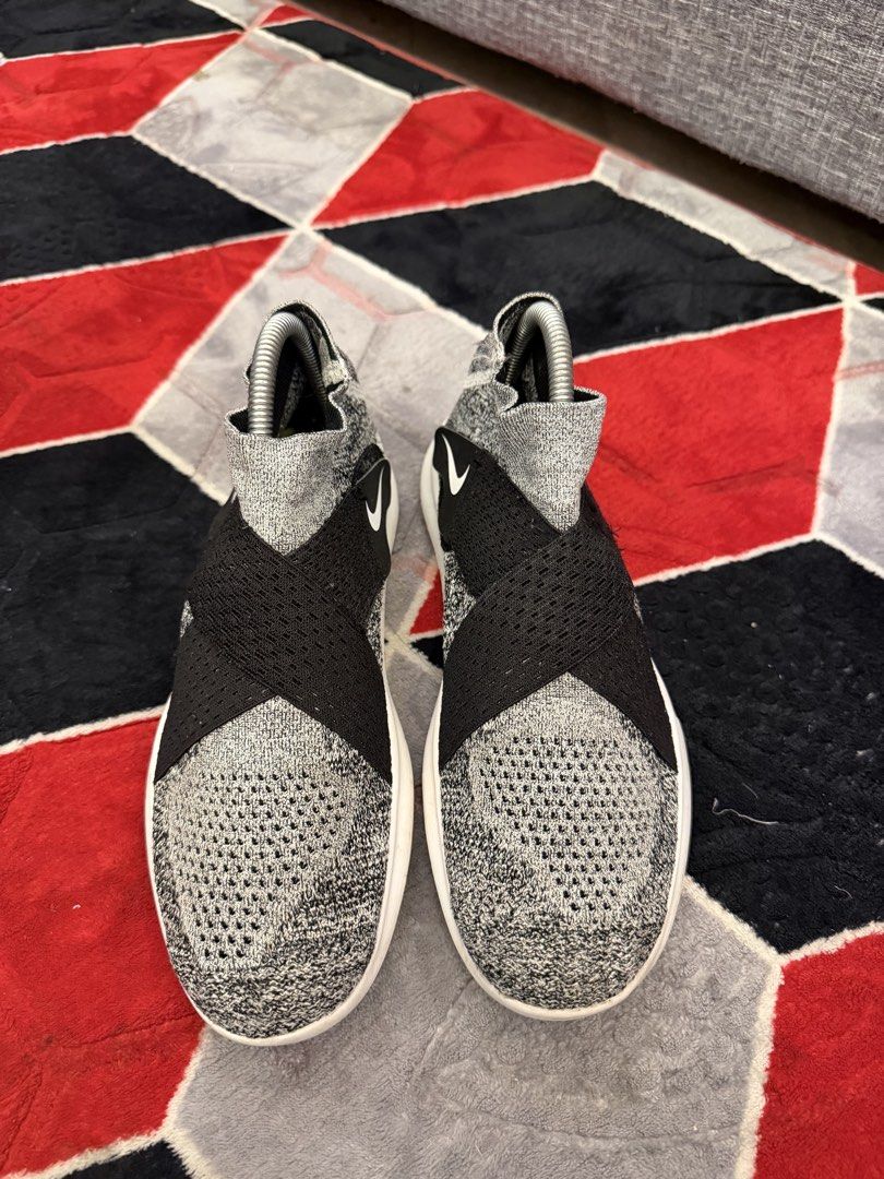 Nike Free RN Flyknit 2018 Sneakers (Category: Sneakers) located in San Jose. Submitted by affordabletrendsby_cai (Listing ID 1438034213, Image 1). Description: Nike Free RN Flyknit 2018 sneakers. Features a gray and black Flyknit upper with a black strap and white sole. The Nike swoosh logo is visible on the side. The sole is white with "NIKE FREE" printed on the side. The shoes have a sock-like fit..
