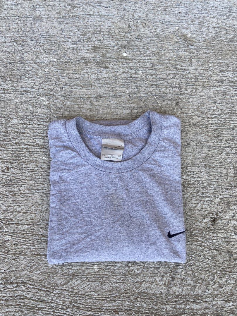 Nike Gray T-shirt (Category: Tshirts & Polo Shirts ) located in Lapu Lapu. Submitted by trip-thrift (Listing ID 1438010195, Image 1). Description: - Gray Nike t-shirt - Crew neck style - Small black logo on chest and sleeve - Standard fit - Minor tear on shoulder.