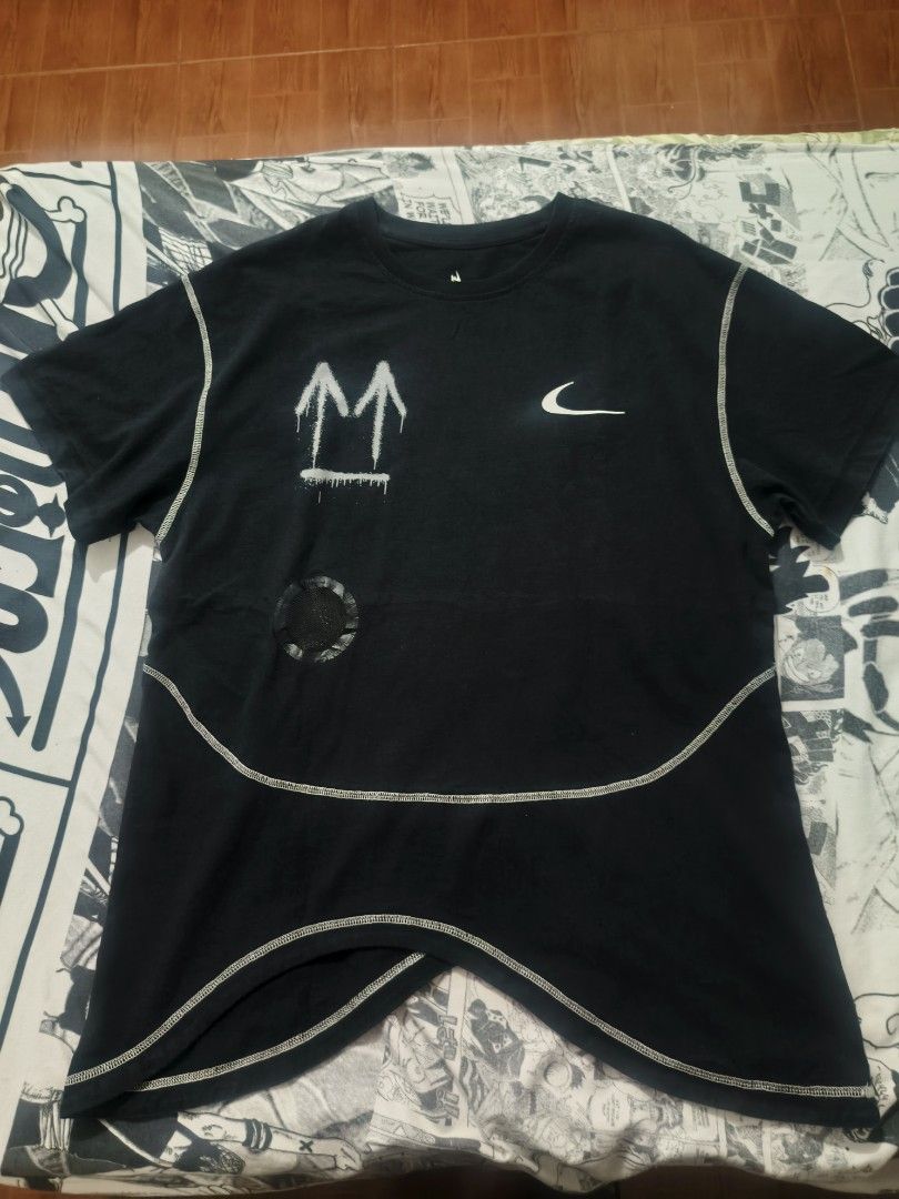Nike Off-White T-Shirt (Category: Tshirts & Polo Shirts ) located in Las Pinas. Submitted by live_marticko (Listing ID 1438063143, Image 1). Description: - Black Nike Off-White T-shirt ✅Size: M on tag (Best fit L to semiXL) ✅Color: Black ✅Dimension: Width: 23" Length: 28" ✅Colorate: 9.6/10 - White stitching details - Features Nike logo and Off-White graphics - Includes size and care label - Unique curved hemline - Spray-painted arrow design.