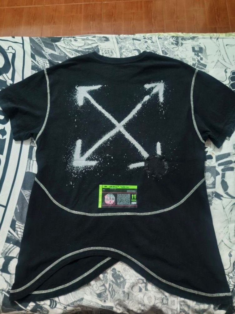 Nike Off-White T-Shirt (Category: Tshirts & Polo Shirts ) located in Las Pinas. Submitted by live_marticko (Listing ID 1438063143, Image 2). Description: - Black Nike Off-White T-shirt ✅Size: M on tag (Best fit L to semiXL) ✅Color: Black ✅Dimension: Width: 23" Length: 28" ✅Colorate: 9.6/10 - White stitching details - Features Nike logo and Off-White graphics - Includes size and care label - Unique curved hemline - Spray-painted arrow design.