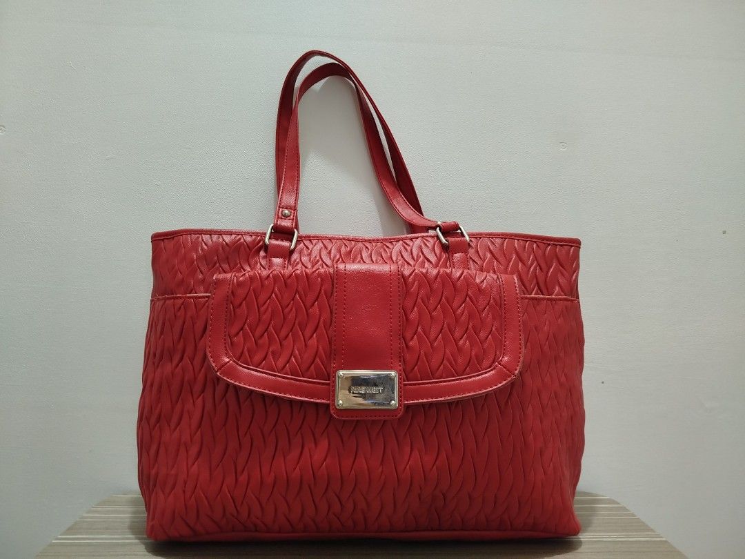 Nine West Red Textured Leather Tote Bag (Category: Shoulder Bags) located in Cavite. Submitted by prncs.jc (Listing ID 1438003128, Image 1). Description: Product Description: - Item: Nine West Red Textured Leather Tote Bag - Color: Vibrant Red - Material: Genuine Leather - Closure: Magnetic snap button closure with an internal tab - Handle/Strap: Dual leather shoulder straps with silver-tone hardware Interior: - Beige fabric lining - One internal