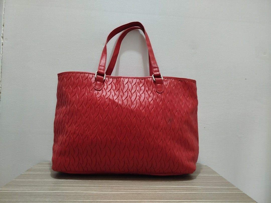Nine West Red Textured Leather Tote Bag (Category: Shoulder Bags) located in Cavite. Submitted by prncs.jc (Listing ID 1438003128, Image 3). Description: Product Description: - Item: Nine West Red Textured Leather Tote Bag - Color: Vibrant Red - Material: Genuine Leather - Closure: Magnetic snap button closure with an internal tab - Handle/Strap: Dual leather shoulder straps with silver-tone hardware Interior: - Beige fabric lining - One internal