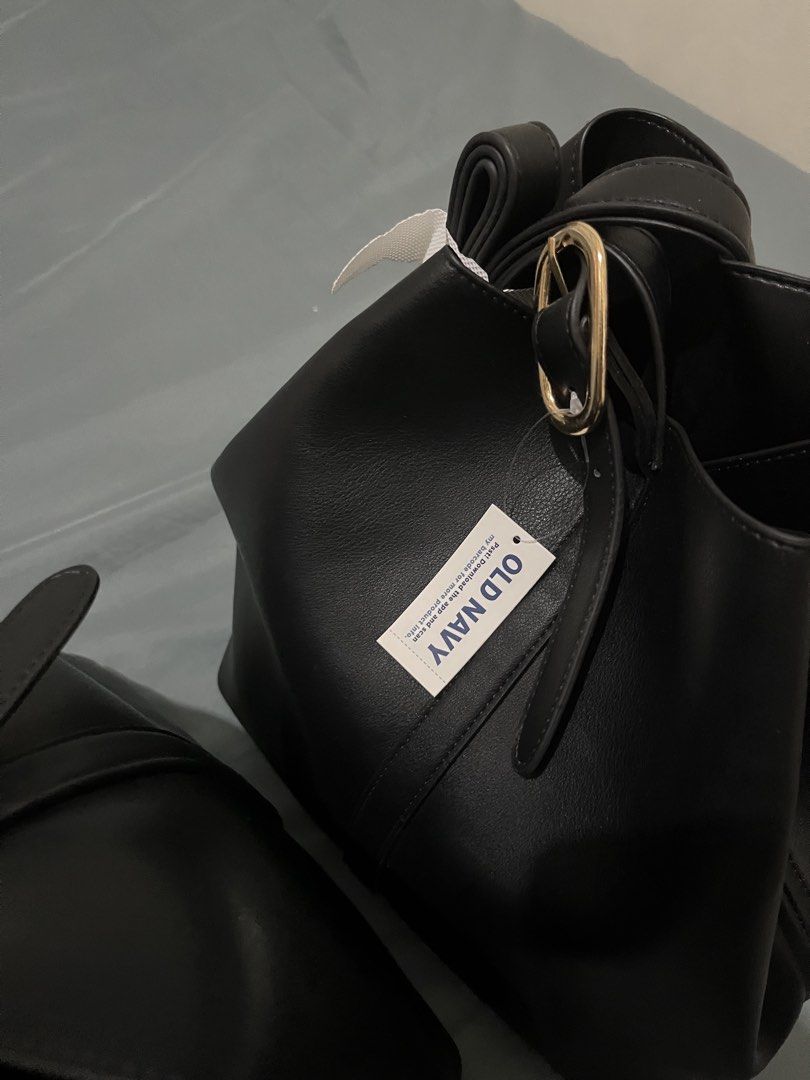 Old Navy Black Bucket Bag (Category: Tote Bags) located in Quezon City. Submitted by simplelang22 (Listing ID 1437985758, Image 1). Description: - Old Navy black bucket bag - Stylish design - Gold-tone buckle detail - Comfortable shoulder strap - Made of smooth faux leather - Spacious interior for everyday essentials - Includes original Old Navy tag.
