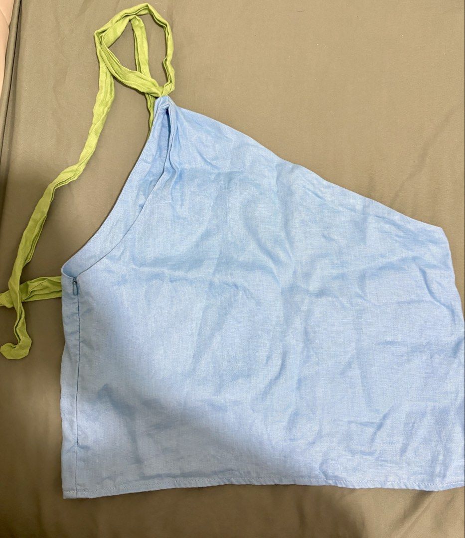 Out and About MNL Frida One Shoulder Top (Category: Sleeveless) located in Mandaluyong City. Submitted by stephanieh55140 (Listing ID 1438058618, Image 2). Description: - Out and About MNL Frida One Shoulder Top - Color: Light Blue with Green Strap - Size: Medium - Fabric: Lightweight - Perfect for casual outings and beach trips - Comfortable and stylish design.
