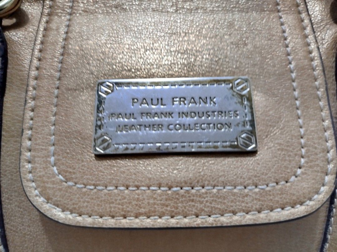 Paul Frank Leather Collection Satchel/Handbag (Category: Shoulder Bags) located in Cavite. Submitted by prncs.jc (Listing ID 1437994732, Image 2). Description: Product Description: - Item: Paul Frank Leather Collection Satchel/Handbag - Color: Metallic Bronze/Tan - Material: Genuine Leather - Closure: Top zipper closure with a decorative magnetic flap - Handle/Strap: Sturdy dual rolled top handles Interior: - Vibrant orange fabric lining with sig