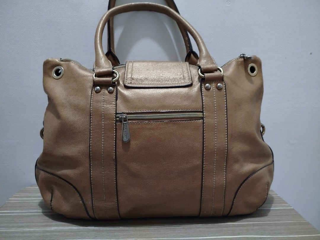 Paul Frank Leather Collection Satchel/Handbag (Category: Shoulder Bags) located in Cavite. Submitted by prncs.jc (Listing ID 1437994732, Image 3). Description: Product Description: - Item: Paul Frank Leather Collection Satchel/Handbag - Color: Metallic Bronze/Tan - Material: Genuine Leather - Closure: Top zipper closure with a decorative magnetic flap - Handle/Strap: Sturdy dual rolled top handles Interior: - Vibrant orange fabric lining with sig
