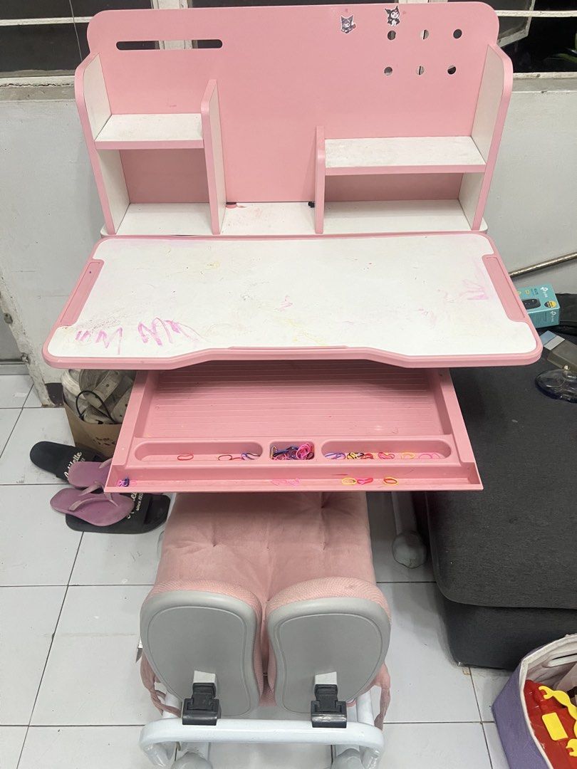 Pink Kids Study Desk and Chair Set (Category: Tables & Sets) located in Valenzuela. Submitted by jannvsantos (Listing ID 1438065681, Image 1). Description: - Pink and white kids' study desk and chair set. - Desk features a built-in shelf and pull-out drawer. - Chair has a unique backrest design. - Both desk and chair have adjustable height. - Perfect for children!.