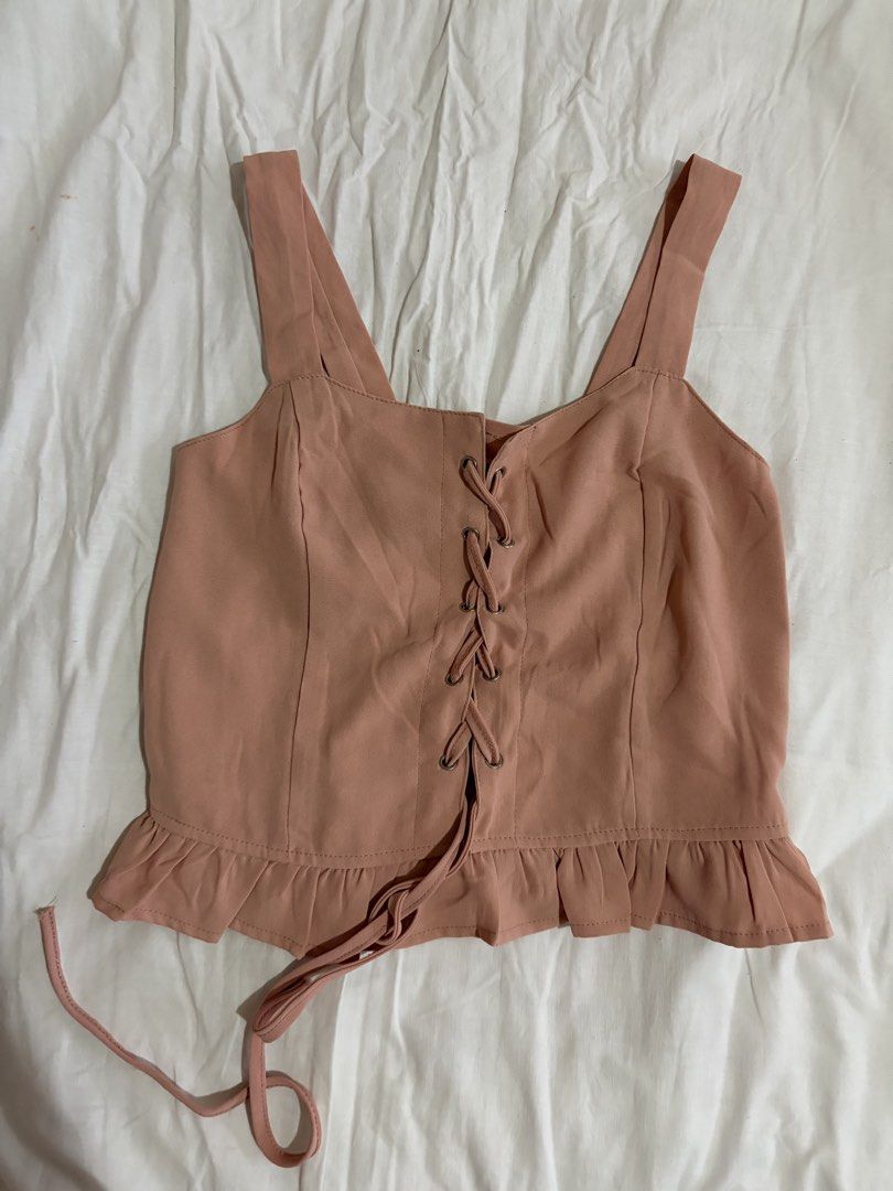 Pink Lace-Up Cami Top (Category: Sleeveless) located in Manila. Submitted by andreacap (Listing ID 1437963816, Image 1). Description: - Pink cami top - Lace-up front detail - Ruffled hem - Wide straps - Smocked back for comfort - Stylish and versatile 🎀 currently decluttering/selling pre-loved clothes, check my page for more details! 🎀 please manage expectations, you may send me a dm for more photos 🎀 my tops and bottoms fits xs-m 🎀 height: 5