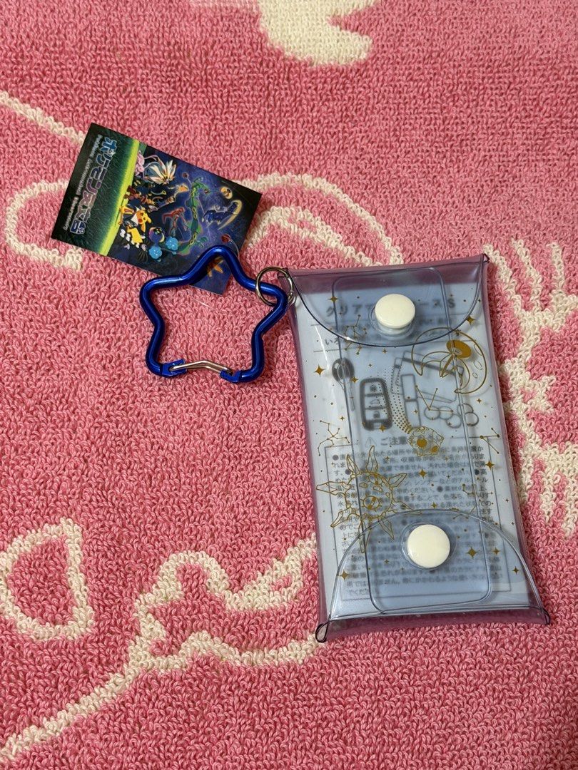 Pokemon Astronomical Observatory Card Holder (Category: Wallets & Card Holders) located in Bacoor. Submitted by vikkavi (Listing ID 1438083631, Image 2). Description: - Pikachu card holder with a cosmic design. - Features a star-shaped carabiner. - Comes with a tag featuring Japanese text and Pokemon characters. - Presented in a clear plastic case with snap closures. - Design includes constellations and "Pokemon Astronomical Observatory" text..