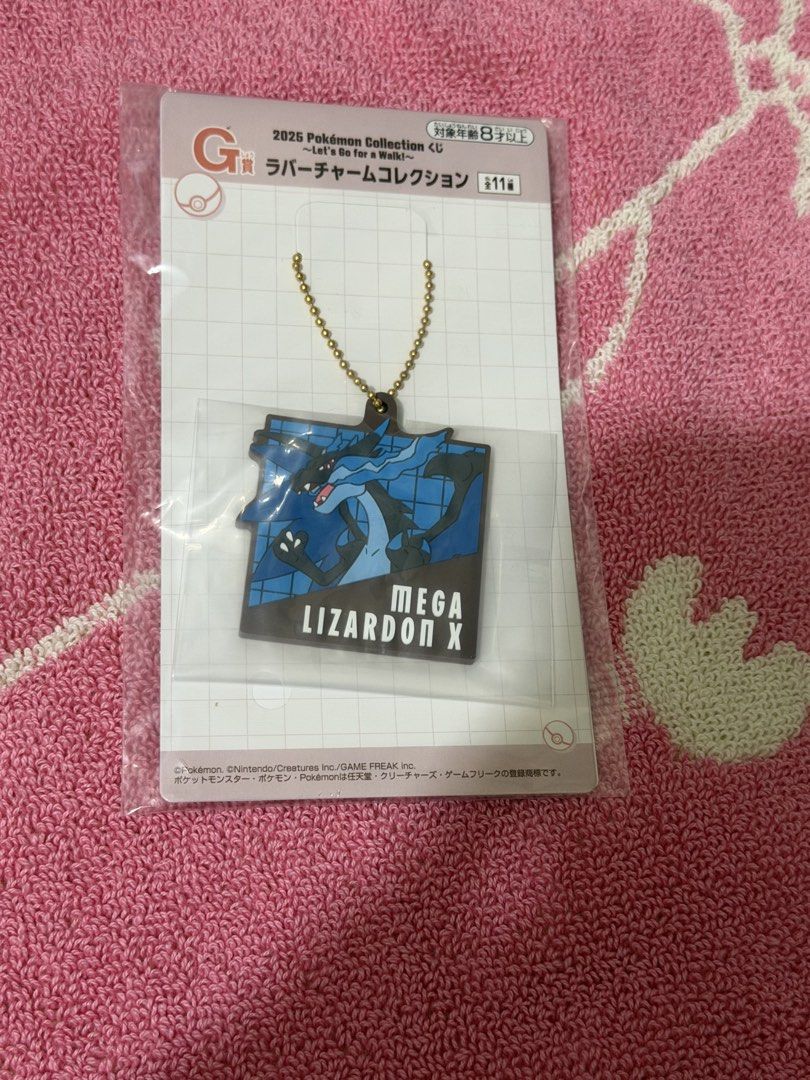 Pokemon Kuji 2025 Collection Mega Charizard X Rubber Charm (Category: Character Goods) located in Bacoor. Submitted by vikkavi (Listing ID 1438084994, Image 1). Description: - Pokemon 2025 Collection rubber charm - Features Mega Charizard X - Includes gold-colored chain - Brand new, still in original packaging - Packaging includes Japanese text and barcode - Manufactured by Bandai Spirits.