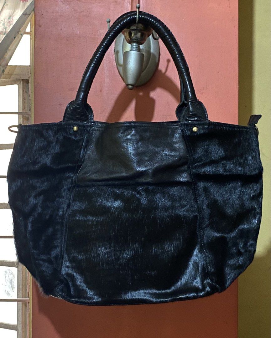 Genuine Pony / Cow Fur Leather Bag (Category: Tote Bags) located in Manila. Submitted by kdclutter (Listing ID 1438098549, Image 1). Description: - Color: Black - Material: Leather with real pony hair / calf hair finish - Large Sized Tote, Spacious interior! - Super good condition - Chic and versatile statement piece - Negotiable!! DM for more deets!.