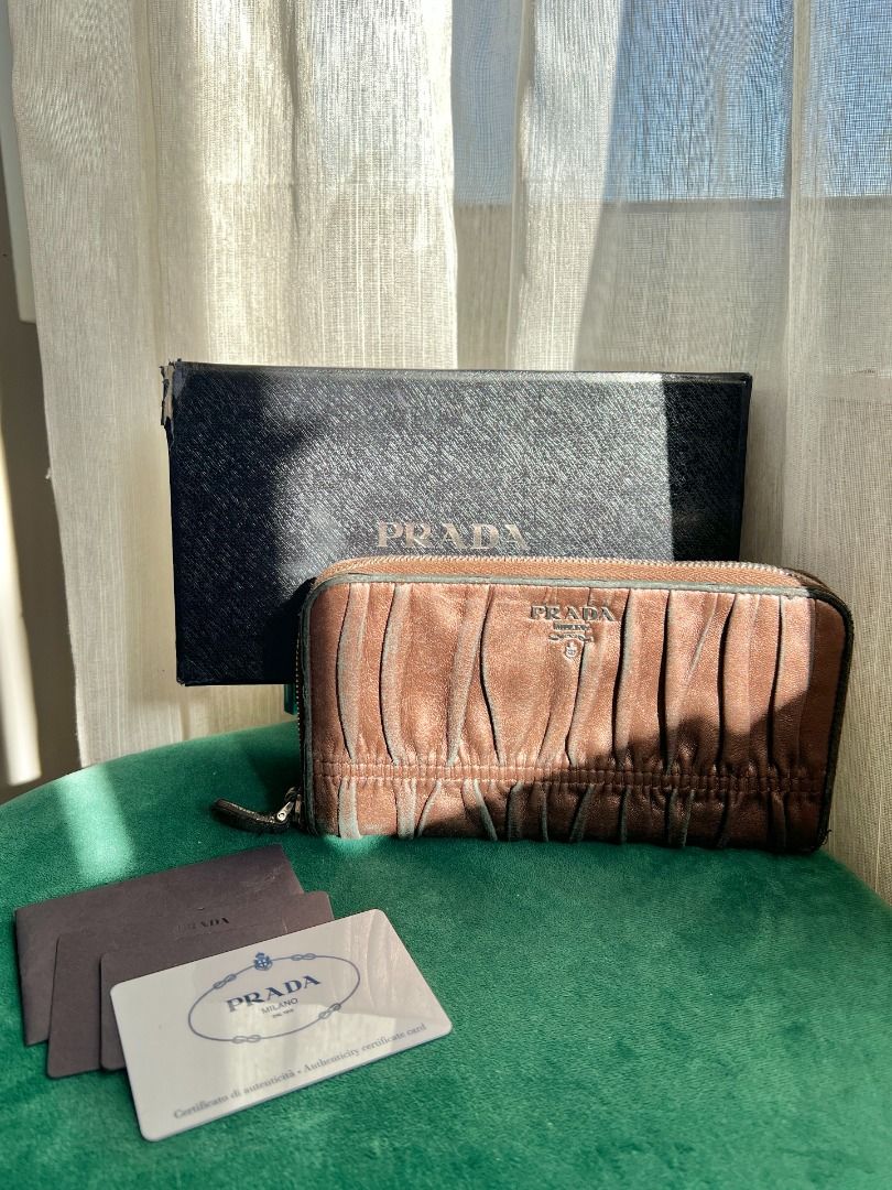 Prada Gaufre Ruched Wallet (Category: Luxury Bags & Wallets) located in Manila. Submitted by iterumlux (Listing ID 1438059388, Image 1). Description: Vintage Prada ruched leather zip wallet crafted in soft nappa leather with Prada Milano metal logo. Features a timeless gathered design, spacious zip-around compartment, and includes original authenticity card and box. Elegant everyday luxury piece with classic Prada aesthetic..