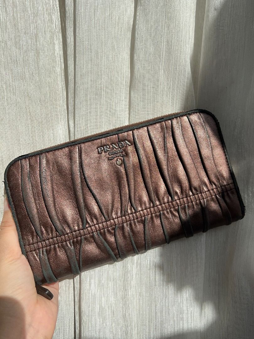 Prada Gaufre Ruched Wallet (Category: Luxury Bags & Wallets) located in Manila. Submitted by iterumlux (Listing ID 1438059388, Image 2). Description: Vintage Prada ruched leather zip wallet crafted in soft nappa leather with Prada Milano metal logo. Features a timeless gathered design, spacious zip-around compartment, and includes original authenticity card and box. Elegant everyday luxury piece with classic Prada aesthetic..