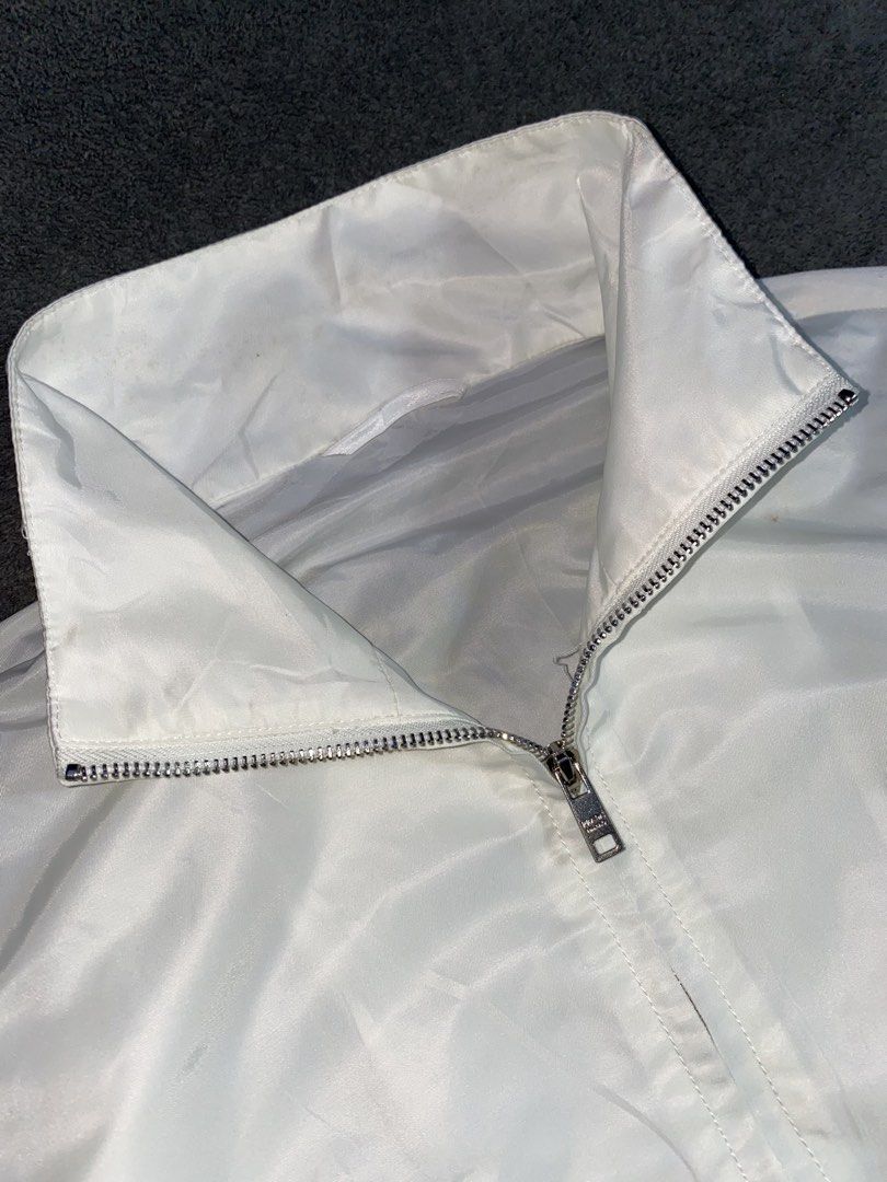 Prada White Cropped Jacket (Category: Coats, Jackets and Outerwear) located in Cebu City. Submitted by arcane_thrift (Listing ID 1437945275, Image 2). Description: - Cropped jacket - High collar - Full-length zipper with Prada Milano zipper pulls - Two front pockets - Drawstring hem - Strap detail on sleeves.