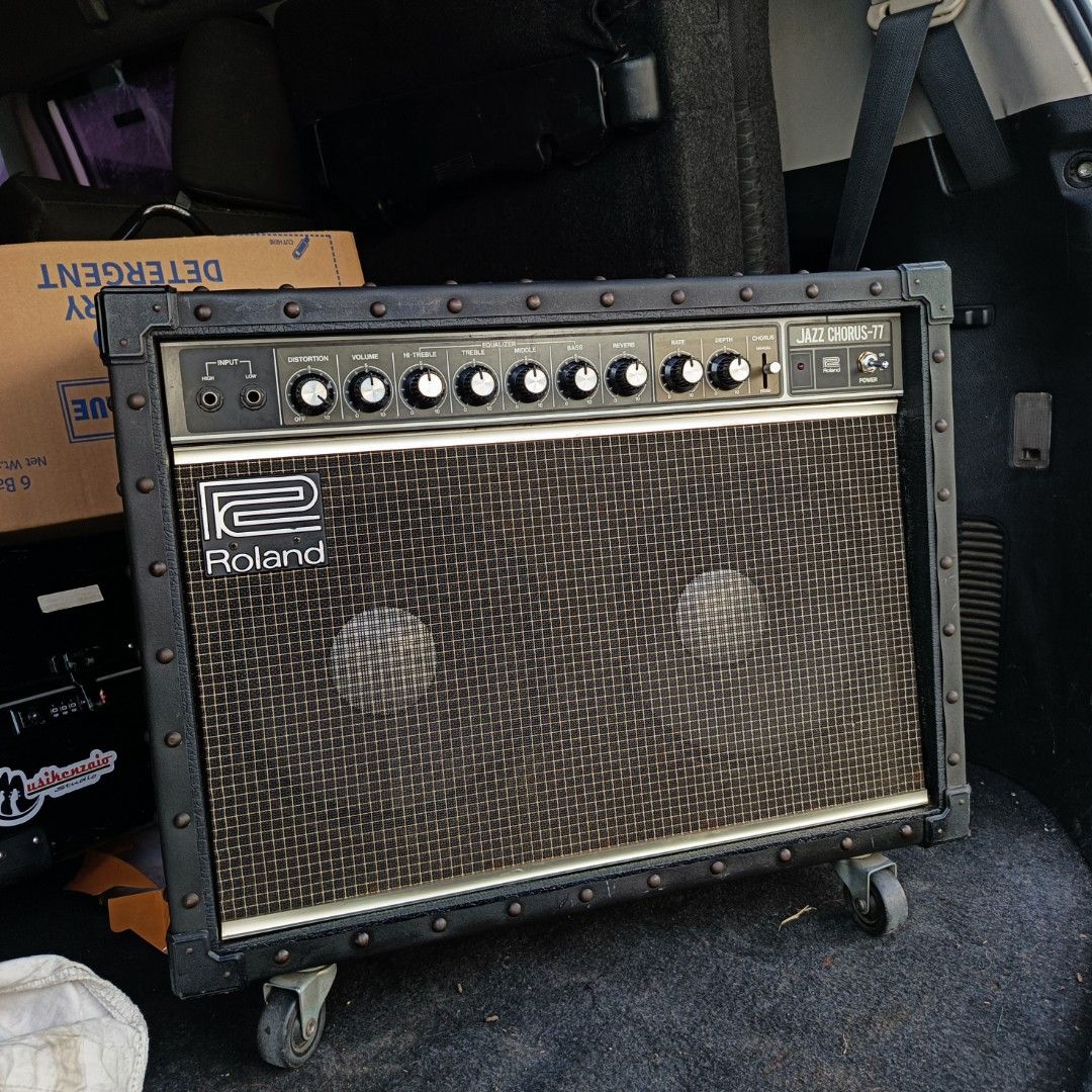 Roland Jazz Chorus-77 Guitar Amplifier (Category: Musical Instruments) located in Bulacan. Submitted by mykillseijin (Listing ID 1438078414, Image 3). Description: fs/ft - Roland Jazz Chorus-77 guitar amplifier - Classic black design - Metal corner protectors - Controls: Volume, Chorus, Rate, Depth - Power switch included - Features the Roland logo - Mounted on wheels for easy transport.