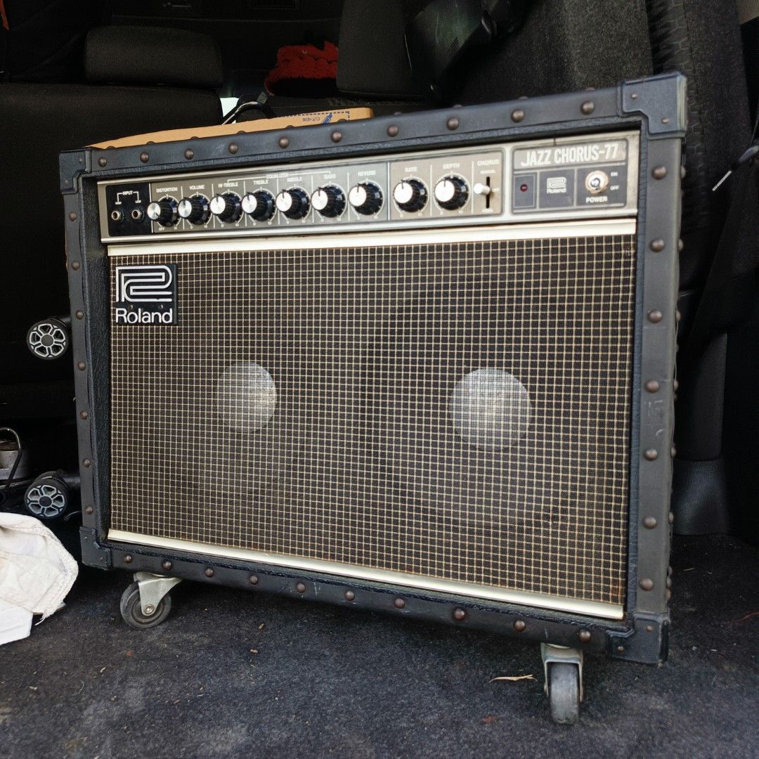 Roland Jazz Chorus-77 Guitar Amplifier (Category: Musical Instruments) located in Bulacan. Submitted by mykillseijin (Listing ID 1438078414, Image 2). Description: fs/ft - Roland Jazz Chorus-77 guitar amplifier - Classic black design - Metal corner protectors - Controls: Volume, Chorus, Rate, Depth - Power switch included - Features the Roland logo - Mounted on wheels for easy transport.