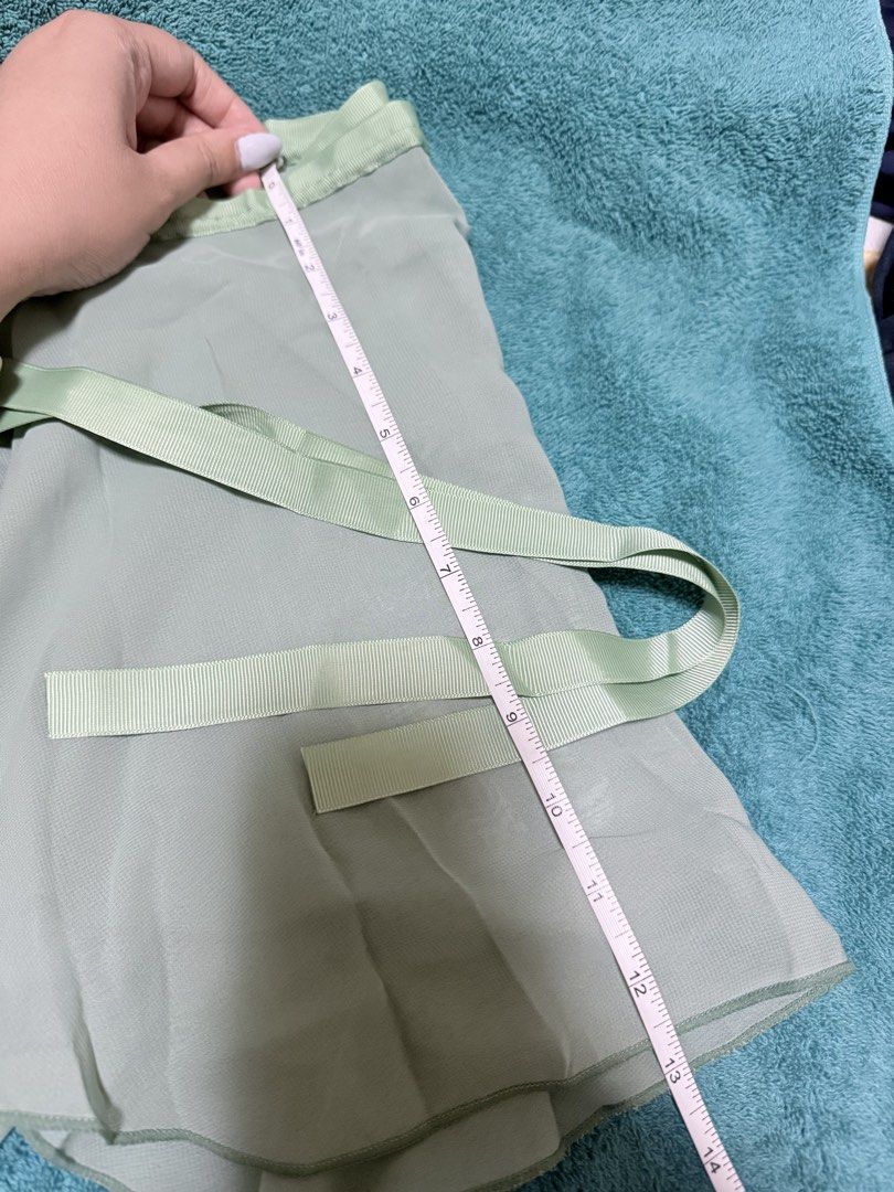 Sage Green Wrap Ballet Skirt (Category: Activewear) located in Pasay City. Submitted by lycheedeclutters (Listing ID 1438078715, Image 2). Description: - Green wrap ballet skirt - Ribbon tie closure - 12 and 1/2 inches in length - 50 inches width (but please take note of the tapered design (4th photo).