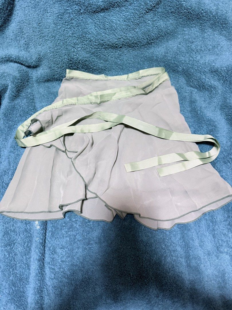 Sage Green Wrap Ballet Skirt (Category: Activewear) located in Pasay City. Submitted by lycheedeclutters (Listing ID 1438078715, Image 1). Description: - Green wrap ballet skirt - Ribbon tie closure - 12 and 1/2 inches in length - 50 inches width (but please take note of the tapered design (4th photo).