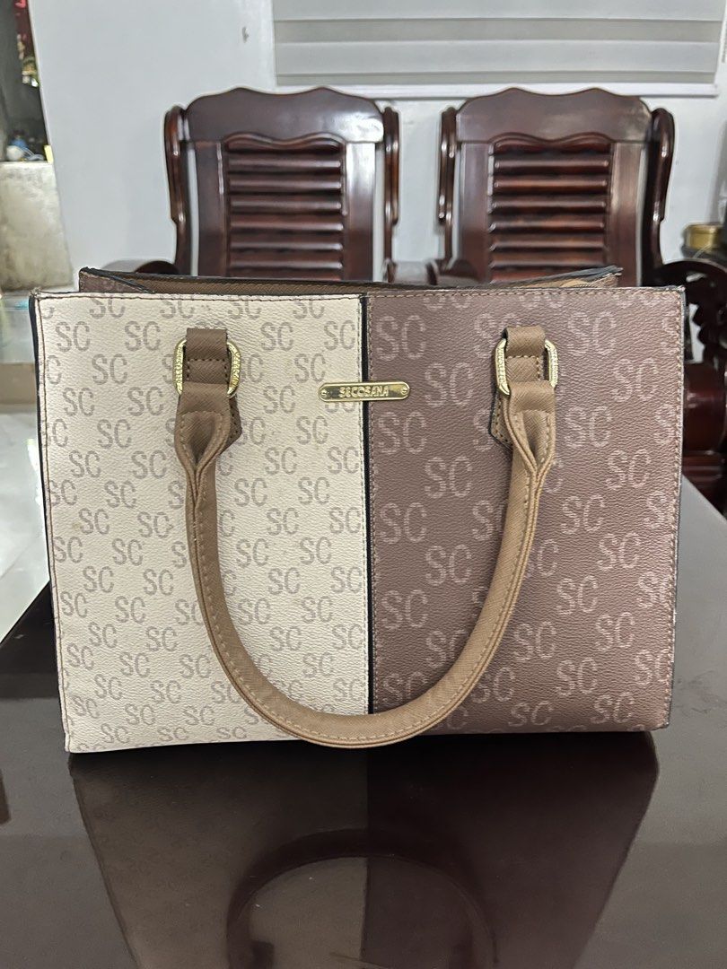 SC Bag with Dual Tone Design (Category: Luxury Bags & Wallets) located in Calamba. Submitted by calamba_declutter (Listing ID 1438009005, Image 1). Description: Secosana - Dual-tone handbag with "SC" logo pattern - Top handle design - Spacious interior with multiple compartments - Includes zippered pocket and additional pockets - Elegant beige and brown color combination - Gold-colored hardware.