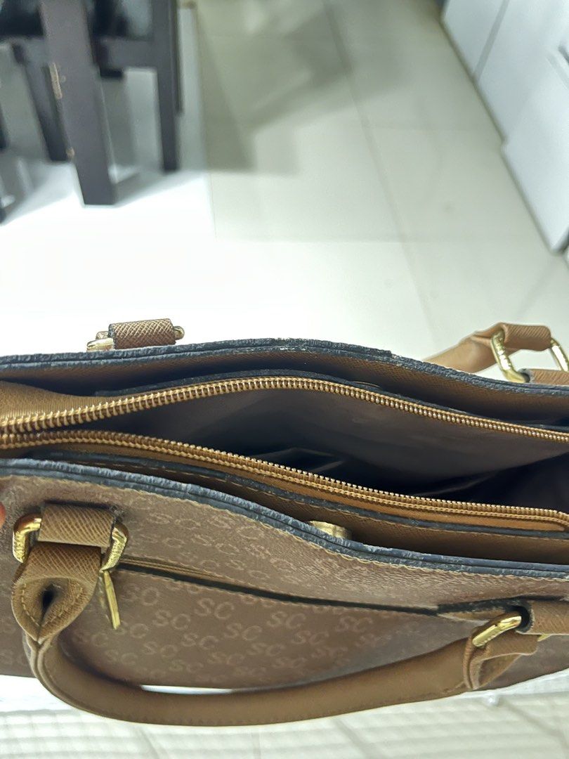 SC Bag with Dual Tone Design (Category: Luxury Bags & Wallets) located in Calamba. Submitted by calamba_declutter (Listing ID 1438009005, Image 3). Description: Secosana - Dual-tone handbag with "SC" logo pattern - Top handle design - Spacious interior with multiple compartments - Includes zippered pocket and additional pockets - Elegant beige and brown color combination - Gold-colored hardware.