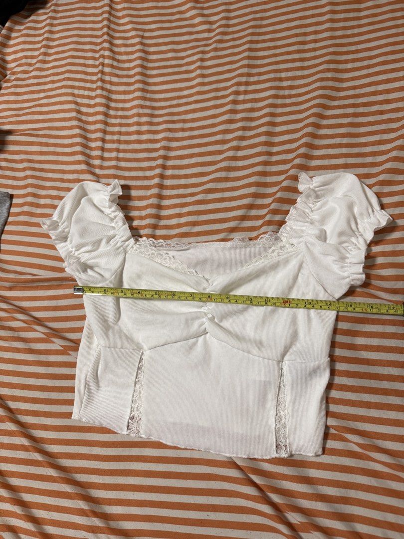 SHEIN White Puff Sleeve Crop Top (Category: Blouses) located in Manila. Submitted by deluxelabphilippines (Listing ID 1438089862, Image 3). Description: - Shein white crop top - Puff sleeves and lace detailing - Square neckline and ruched front - Made in China - Measurements (approximate): - Chest: 14 inches - Length: 10 inches - Size: L tag but fits S-M.
