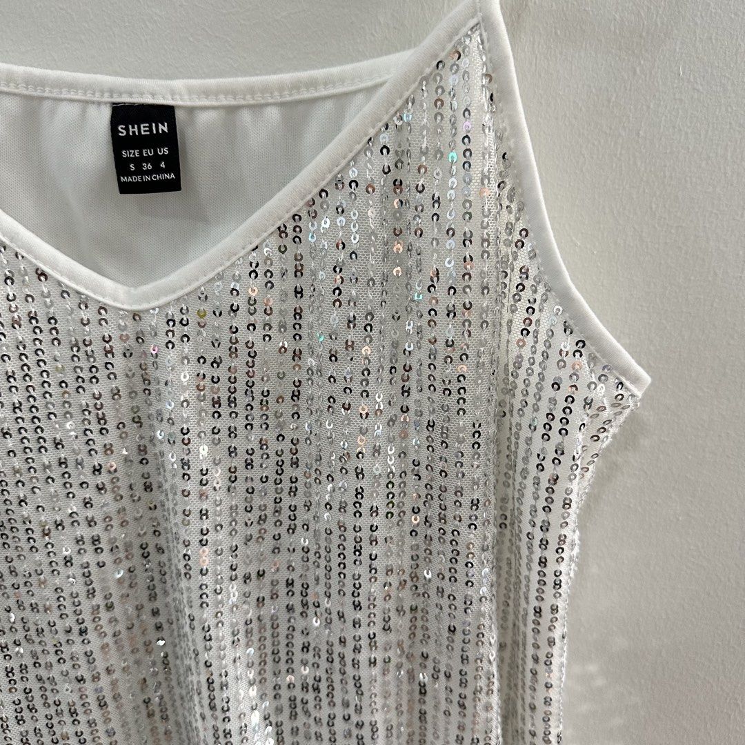 Shimmery Top (Shein) (Category: Blouses) located in Taguig. Submitted by k_bloom (Listing ID 1438109346, Image 2). Description: Item: Top Color: White and Silver Brand: Shein Size: Small Condition: Like New Reason for Selling: Decluttering. Used only once for Party. ——————————————————————— Mode of Payment: Online payment only via Gcash, BPI or BDO Delivery: Shipping fee c/o buyer •Within NCR- via lalamove/grab/J&T/GogoXpress •Outside NCR- via LBC
