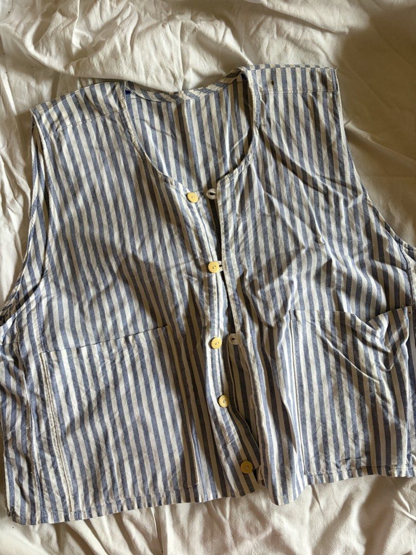 Striped Vest with Buttons (Category: Sleeveless) located in Manila. Submitted by andreacap (Listing ID 1437966793, Image 1). Description: - Blue and white striped pattern - Button-up front - Round neckline - Two front pockets - Lightweight fabric - Sleeveless design - Minor tear on the side - Minor stains 🎀 currently decluttering/selling pre-loved clothes, check my page for more details! 🎀 please manage expectations, you may send me a dm for mo