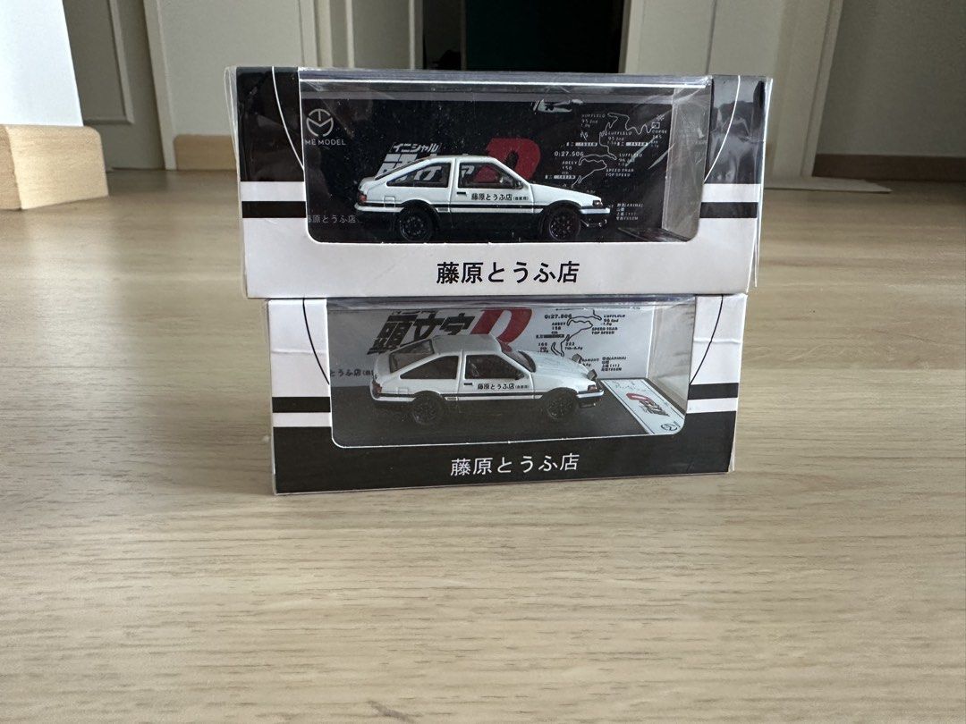 Time Model Initial D AE86 (Category: Vehicle & Diecast Models) located in Kuala Lumpur. Submitted by i3igdaddy (Listing ID 1438014186, Image 3). Description: - Time Model Initial D AE86 diecast model. - RM85 each, both RM160 - Features the iconic white and black color scheme. - Comes in original packaging. - Packaging includes the Initial D logo and Japanese text. - Clear window allows viewing of the model car. - Includes a small map. - Brand New