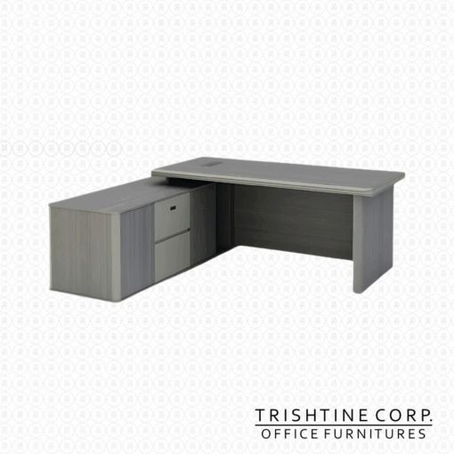 TXT-070 L-Shaped Office Desk (Category: Office Furniture & Fixtures) located in Caloocan City. Submitted by trishtine_jim9 (Listing ID 1437985818, Image 2). Description: - L-shaped office desk - Brand: Trishtine Corp. - Color: Light gray wood finish - Features a built-in drawer unit (2 drawers) and cabinet - Rectangular shape - Built-in cable management port - Ideal for office or home office.