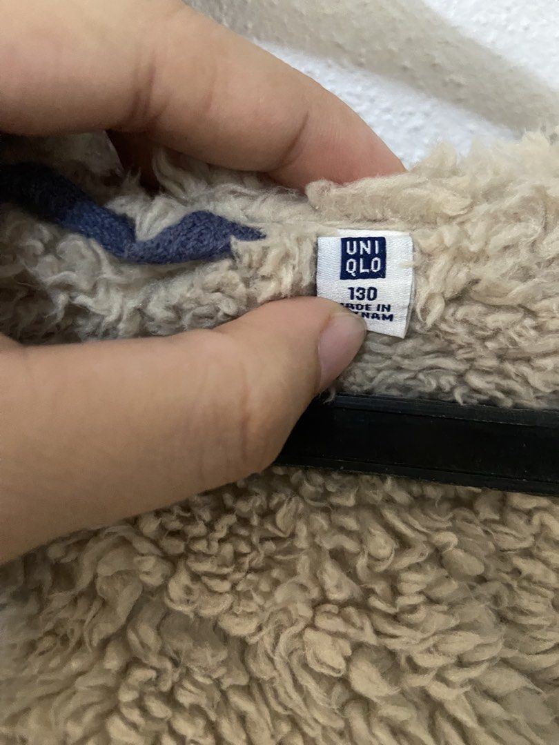 Uniqlo Kids Fleece Lined Jacket (Category: Babies & Kids Fashion) located in Mabalacat. Submitted by cllctbls_ (Listing ID 1438009296, Image 3). Description: Uniqlo Kids jacket with fleece lining. Features a full zip closure, hood, and two front pockets. The jacket is a blue color with a beige fleece lining. Size 130. Made in Vietnam..