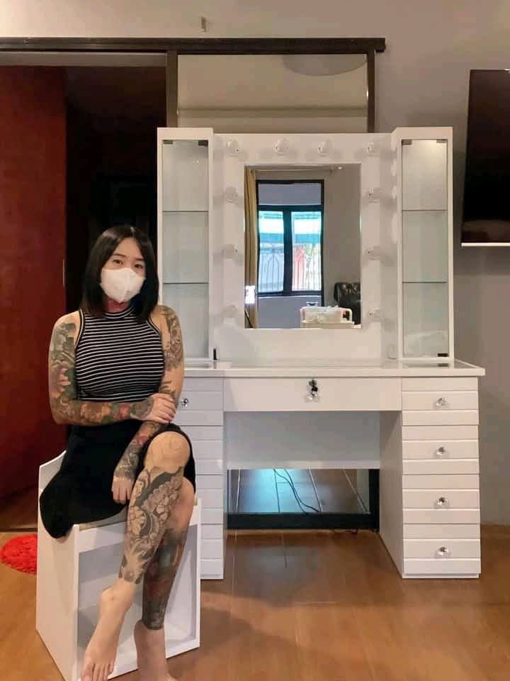 Vanity Table with Lights and Stool (Category: Tables & Sets) located in Mabalacat. Submitted by joemamangun01 (Listing ID 1437989024, Image 3). Description: - Vanity table with built-in mirror and lights - Multiple drawers and side cabinets for storage - Includes matching stool with cushioned seat - Wooden table top - White frame - Ideal for bedroom or dressing area.