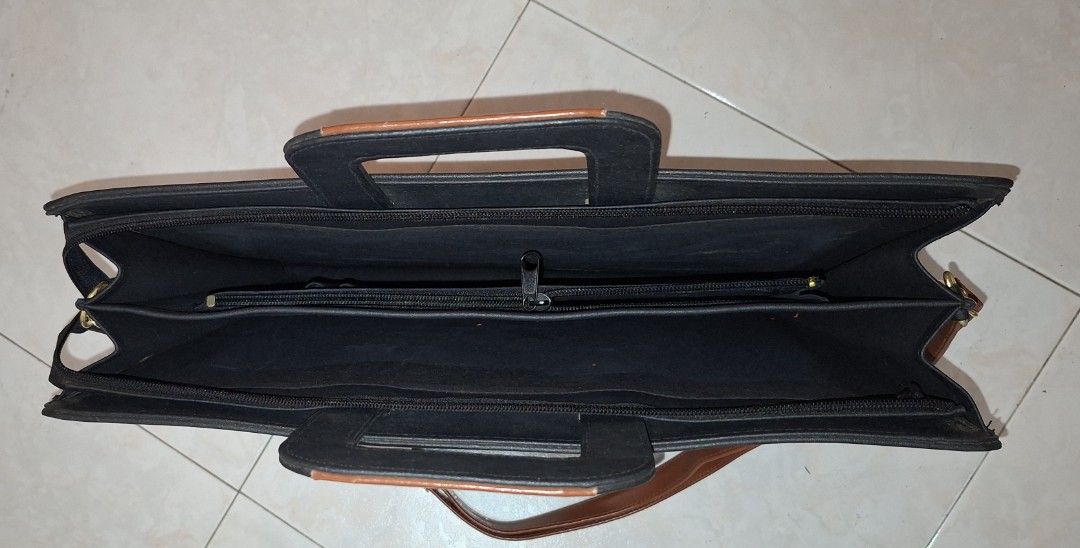 Classic Brown Briefcase (Category: Briefcases) located in Singapore. Submitted by hk267066 (Listing ID 1437726335, Image 3). Description: Vintage black, brown briefcase with shoulder strap and two untarnished gold buckle closures. Excellent condition. Size: 43cm Length by 33 cm Breadth. Perfect for carrying documents or a laptop. Self-collection. New one may cost about $500..