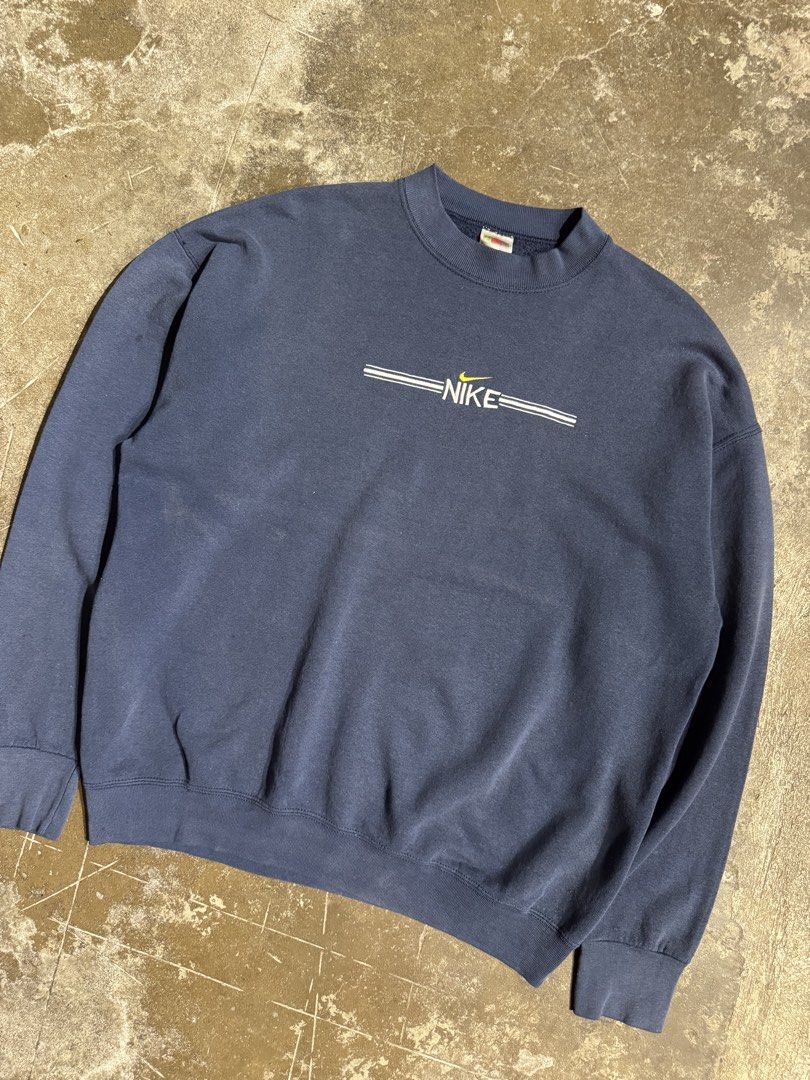 Vintage Nike Bootleg Crewneck Jacket (Category: Coats, Jackets and Outerwear) located in Cavite. Submitted by dracokidstuff (Listing ID 1438037025, Image 2). Description: Vintage Nike Bootleg Crewneck Jacket Size: XL Dimes: W25 L27 SL23 Very good condition Issue bleach stain - Vintage Nike sweatshirt - Navy blue color - Nike logo on chest - Made by Fruit of the Loom - Size: XL - Minor wear on sleeves.