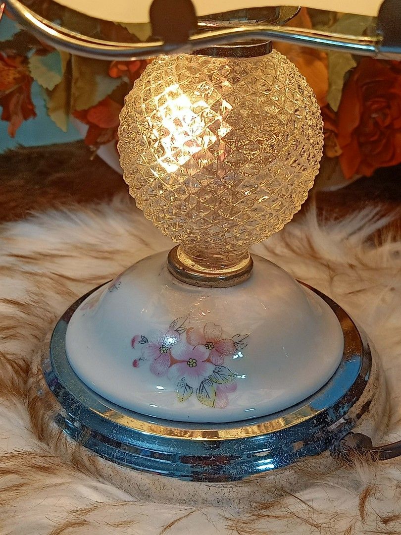 Vintage Tiffany Style Touch Lamp (Category: Lighting) located in Meycauayan. Submitted by youngdeer.86663a (Listing ID 1437938556, Image 3). Description: Elegant vintage table lamp featuring a floral design on the lampshade. The lamp has a decorative base with floral accents and a crystal-like sphere. It has a silver-colored metal base and a matching top. The lamp is designed to provide soft, ambient lighting, perfect for adding a touch of vintag