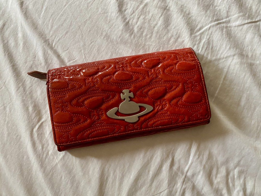 Vivienne Westwood Red Embossed Long Wallet (Category: Luxury Bags & Wallets) located in Quezon City. Submitted by ____sampai (Listing ID 1438003265, Image 1). Description: Self Authenticated Flaw: Mark on the side (see picture).