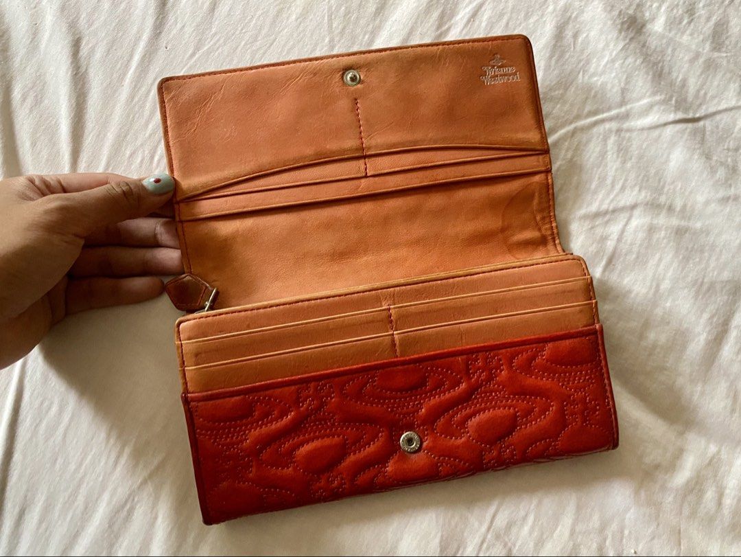 Vivienne Westwood Red Embossed Long Wallet (Category: Luxury Bags & Wallets) located in Quezon City. Submitted by ____sampai (Listing ID 1438003265, Image 3). Description: Self Authenticated Flaw: Mark on the side (see picture).