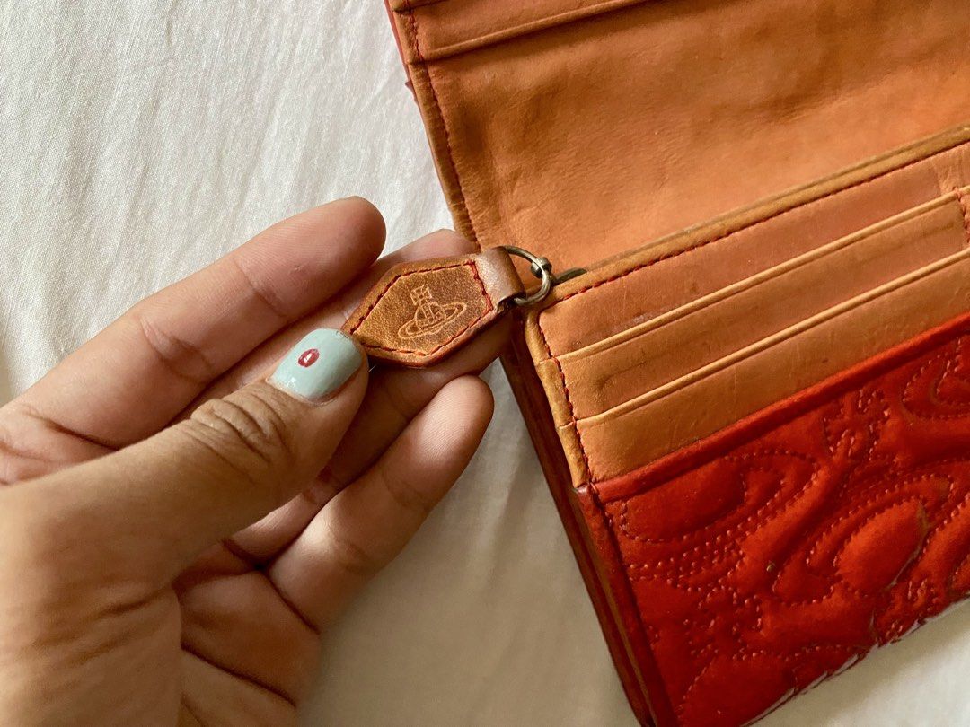 Vivienne Westwood Red Embossed Long Wallet (Category: Luxury Bags & Wallets) located in Quezon City. Submitted by ____sampai (Listing ID 1438003265, Image 2). Description: Self Authenticated Flaw: Mark on the side (see picture).