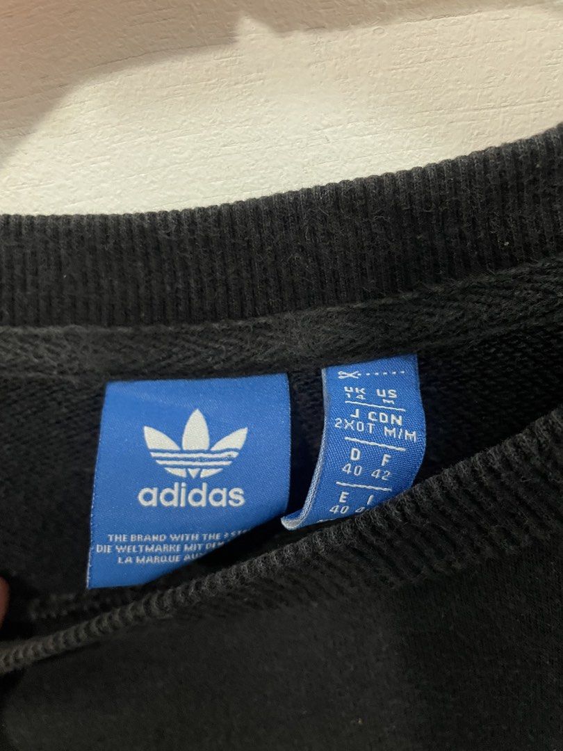 Adidas Black Sweatshirt with White Stripes (Category: Longsleeves) located in Manila. Submitted by ledithgo (Listing ID 1438283253, Image 2). Description: - Adidas black sweatshirt - White stripes on sleeves - Adidas trefoil logo on chest - Size: L - Crew neck - Long sleeves - Comfortable fabric.