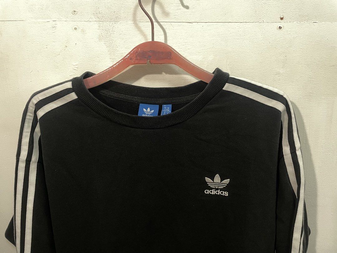 Adidas Black Sweatshirt with White Stripes (Category: Longsleeves) located in Manila. Submitted by ledithgo (Listing ID 1438283253, Image 1). Description: - Adidas black sweatshirt - White stripes on sleeves - Adidas trefoil logo on chest - Size: L - Crew neck - Long sleeves - Comfortable fabric.