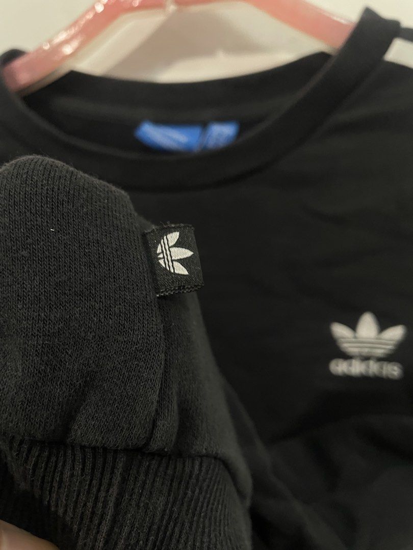 Adidas Black Sweatshirt with White Stripes (Category: Longsleeves) located in Manila. Submitted by ledithgo (Listing ID 1438283253, Image 3). Description: - Adidas black sweatshirt - White stripes on sleeves - Adidas trefoil logo on chest - Size: L - Crew neck - Long sleeves - Comfortable fabric.