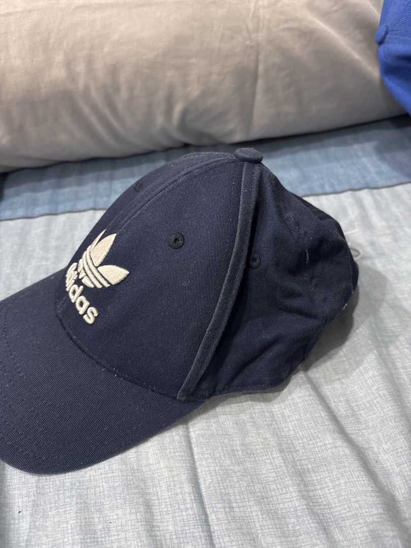 Adidas Cap (Category: Caps & Hats) located in Manila. Submitted by colin92421 (Listing ID 1438288373, Image 2). Description: - Navy blue Adidas cap - Features the iconic Adidas logo - Adjustable strap for a perfect fit - Made from durable fabric - A classic and versatile accessory.
