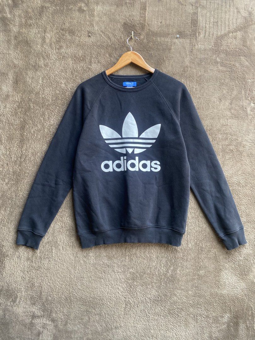Adidas Trefoil Sweatshirt - Black (Category: Coats, Jackets and Outerwear) located in Manila. Submitted by bacilus (Listing ID 1438261731, Image 1). Description: - Authentic Adidas Trefoil sweatshirt - Color: Black - Size: Small - Features the iconic Adidas logo - Crew neck and long sleeves - Made in Pakistan - Classic, sporty style - Material composition visible on tag.