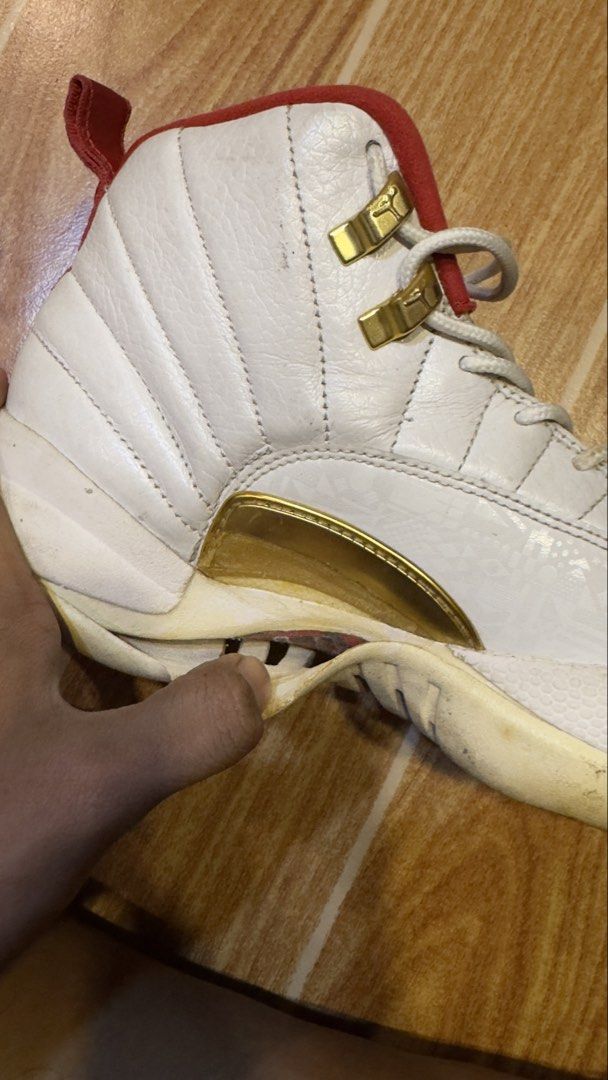 Air Jordan 12 Retro White/Red (Category: Sneakers) located in Manila. Submitted by rylegalapin (Listing ID 1438232855, Image 3). Description: - Air Jordan 12 Retro - Color: White and Red - Condition: Shows wear and tear, sole separation - Features: Gold accents - Inner lining: Red - Size tag visible (NEGO).