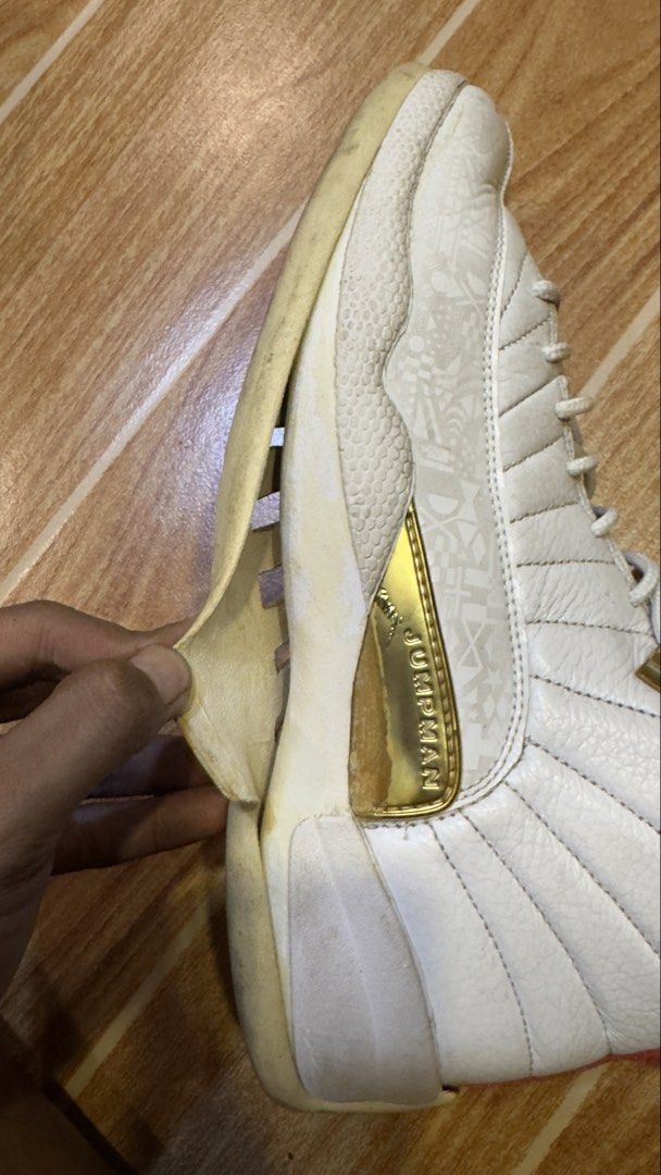 Air Jordan 12 Retro White/Red (Category: Sneakers) located in Manila. Submitted by rylegalapin (Listing ID 1438232855, Image 1). Description: - Air Jordan 12 Retro - Color: White and Red - Condition: Shows wear and tear, sole separation - Features: Gold accents - Inner lining: Red - Size tag visible (NEGO).