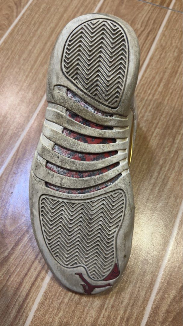 Air Jordan 12 Retro White/Red (Category: Sneakers) located in Manila. Submitted by rylegalapin (Listing ID 1438232855, Image 2). Description: - Air Jordan 12 Retro - Color: White and Red - Condition: Shows wear and tear, sole separation - Features: Gold accents - Inner lining: Red - Size tag visible (NEGO).