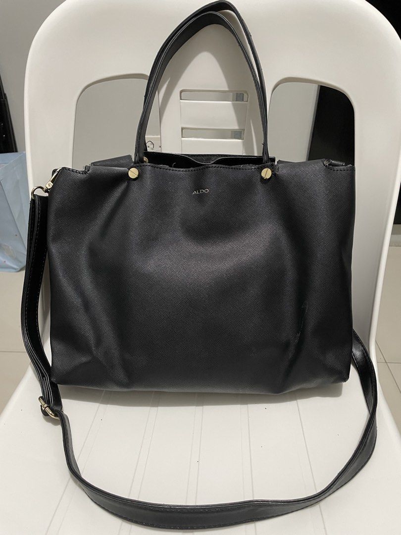 Aldo Black Tote Bag with Shoulder Strap (Category: Tote Bags) located in Taytay. Submitted by annequeen88 (Listing ID 1438221601, Image 2). Description: - Black Aldo tote bag - Gold-colored accents - Rectangular shape - Two top handles - Detachable shoulder strap - Aldo logo visible - Minor wear on shoulder strap - Textured material.